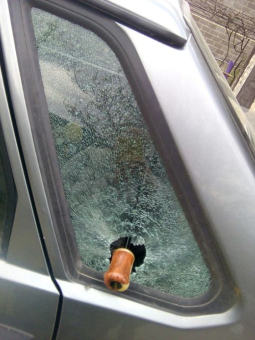Зонтик выбил автомобильное стекло (2 фото)